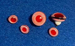 Set of red and pink ceramic buttons on a blue background